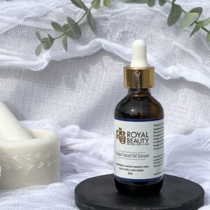 Royal Facial Oil Serum on black disc with plant in background