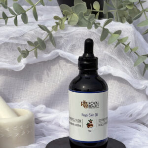 Royal Skin Oil on black disc with plant in background