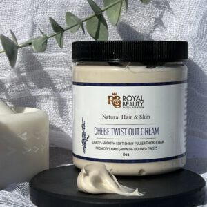 Product on black disc with smear of product and ivy green in background